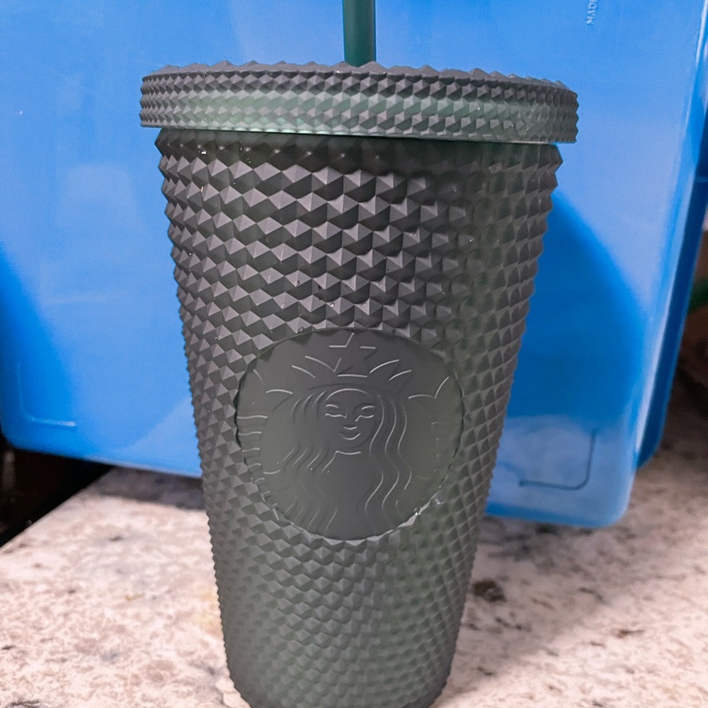 Dark green studded grande Starbucks cup